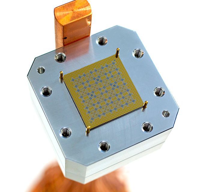 A 64-bit superconducting qubit chip, measuring about 2cm on each side. It is mounted onto a wiring package that connects to the quantum computer.