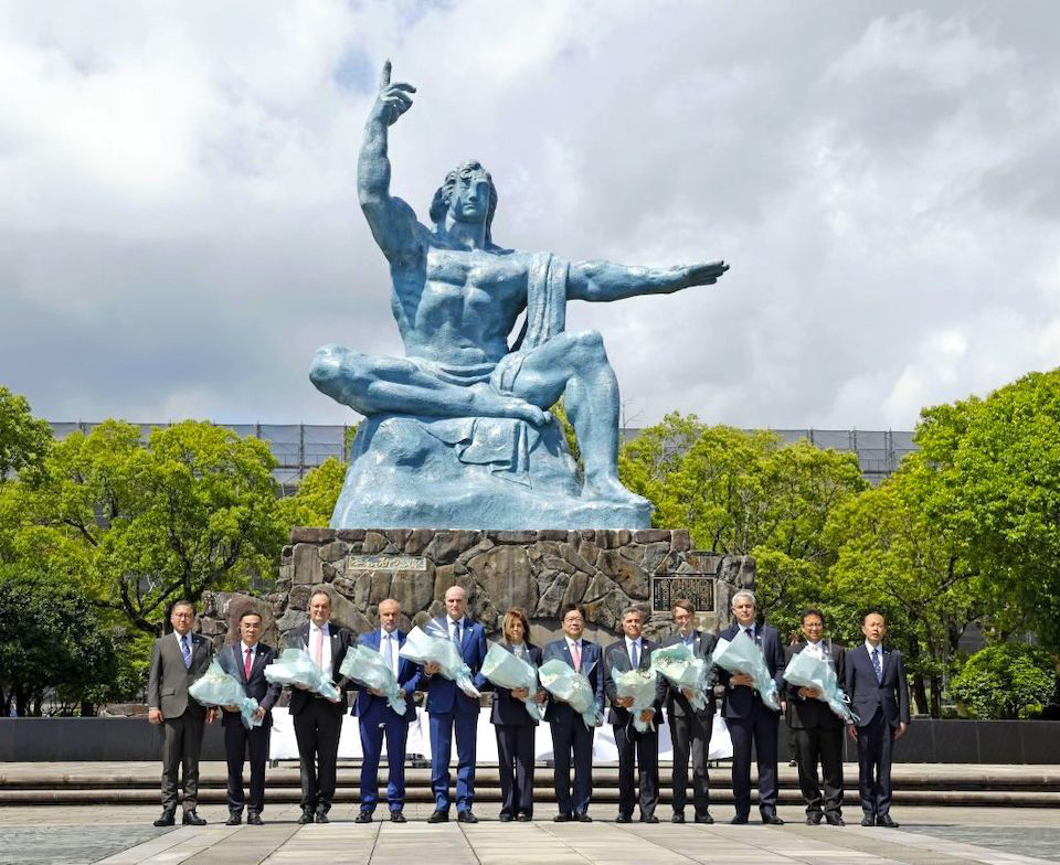 Health Ministers attending G7 Health Ministers' Meeting in Nagasaki holding flowers in front of the Peace Statue.
