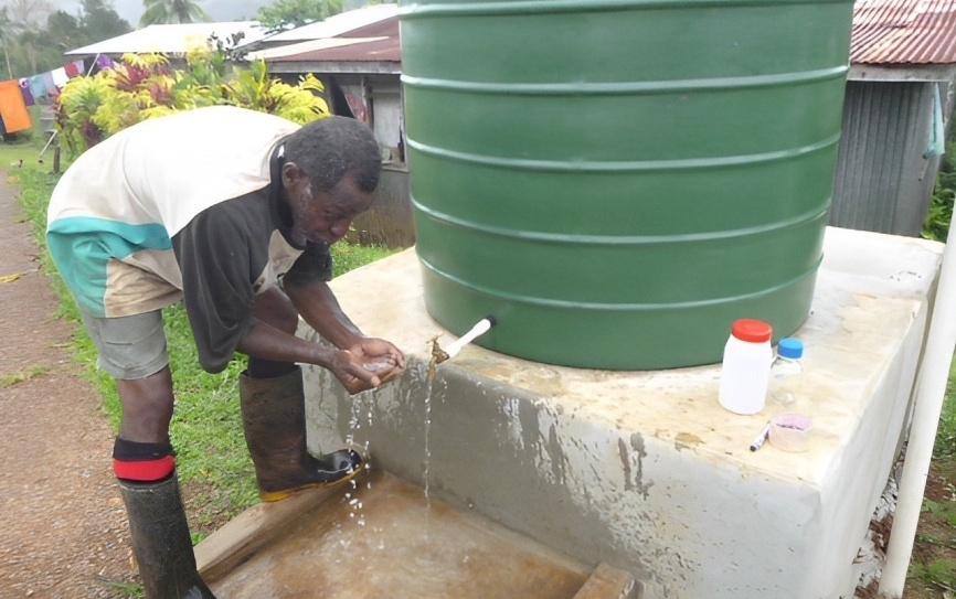 A man trying to use clean water from the Ecological Purification System in Fiji.