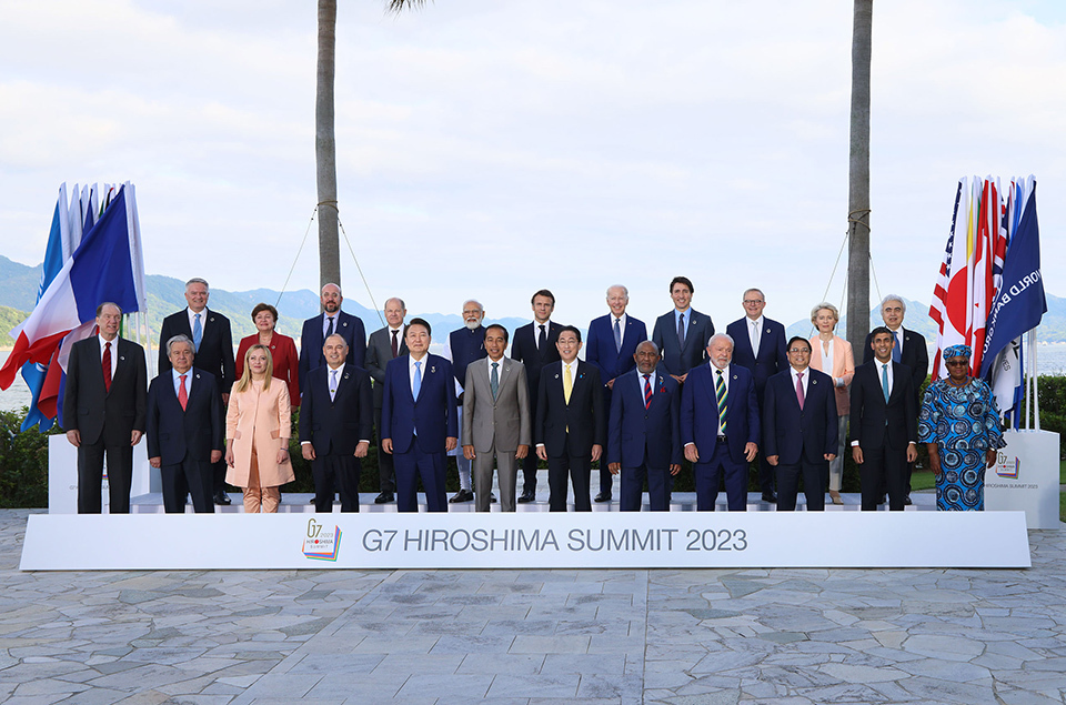 Leaders of the G7 and the invited countries as well as heads of international organizations stand side by side.