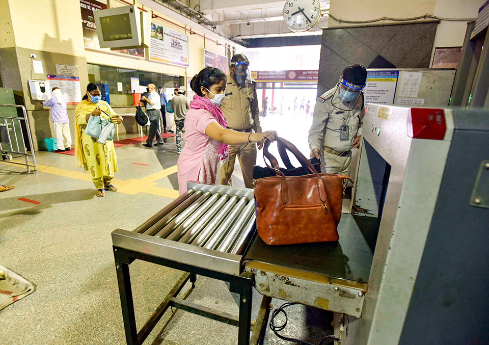 Indian woman going through baggage screening at the entrance of a station of the Delhi Metro in India. GETTY IMAGES