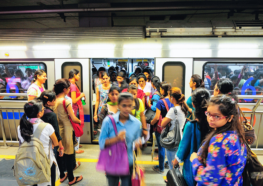 Women-only carriages of the Delhi Metro with full of passengers getting on and off at a station. GETTY IMAGES