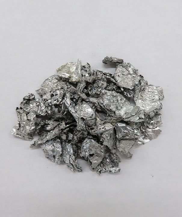 Handful of silver waste aluminum chips which turn into hydrogen.