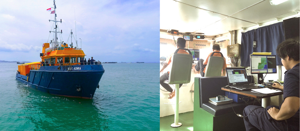 ASEAN-Japan joint hydrographic survey vessel for Straits of Malacca and Singapore. A photo of the interior of the survey vessel's wheelhouse, with two people working at the front window and another seated at the back computer station.