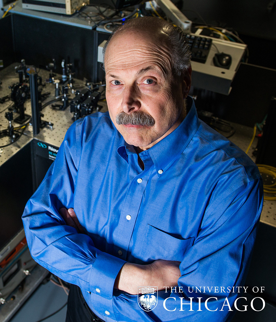 Professor David Awschalom wearing a blue long-sleeved shirt and crossing his arms.