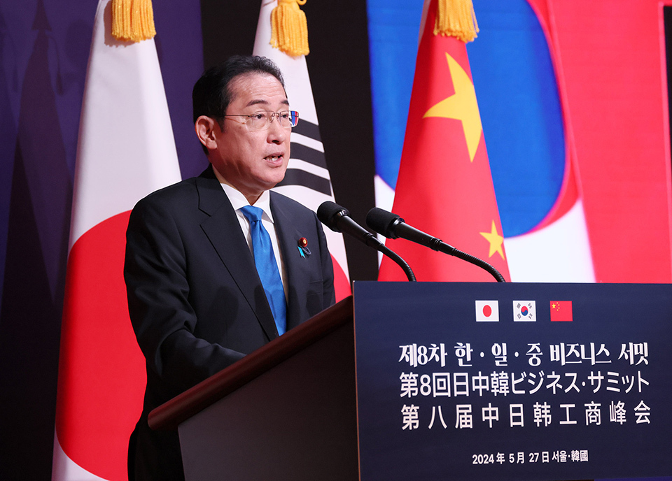 A Person giving a speech at a podium with microphones