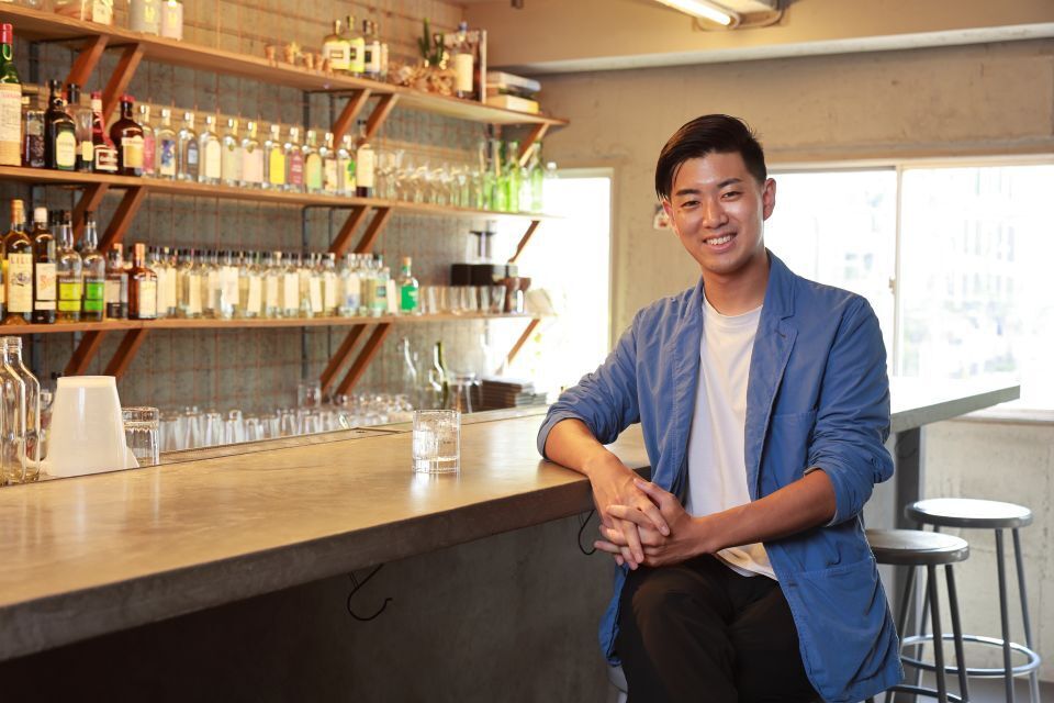 CEO of Ethical Spirits Ono Chikara sitting at the bar counter in the company's head office