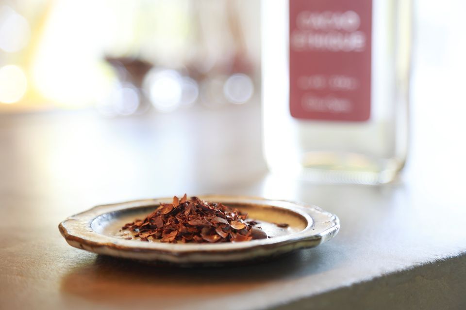 A plate of cacao husks and a bottle of gin made from this ingredient