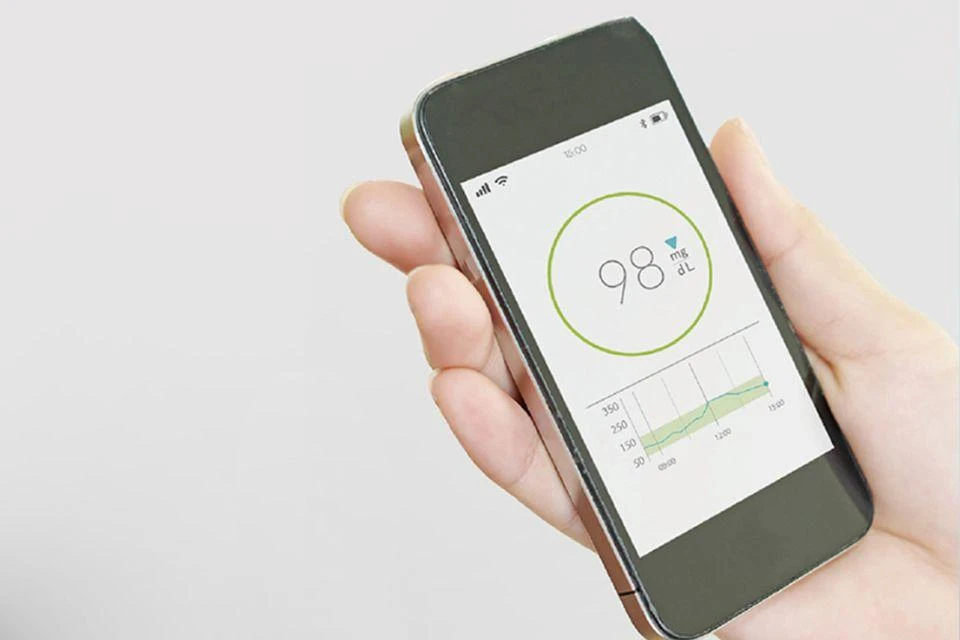 An image of using the blood glucose sensors, showing how results can be viewed on a smartphone