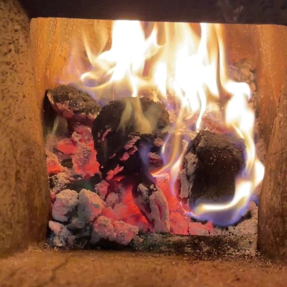 A fire in a roaster entirely fueled by compressed coffee grounds