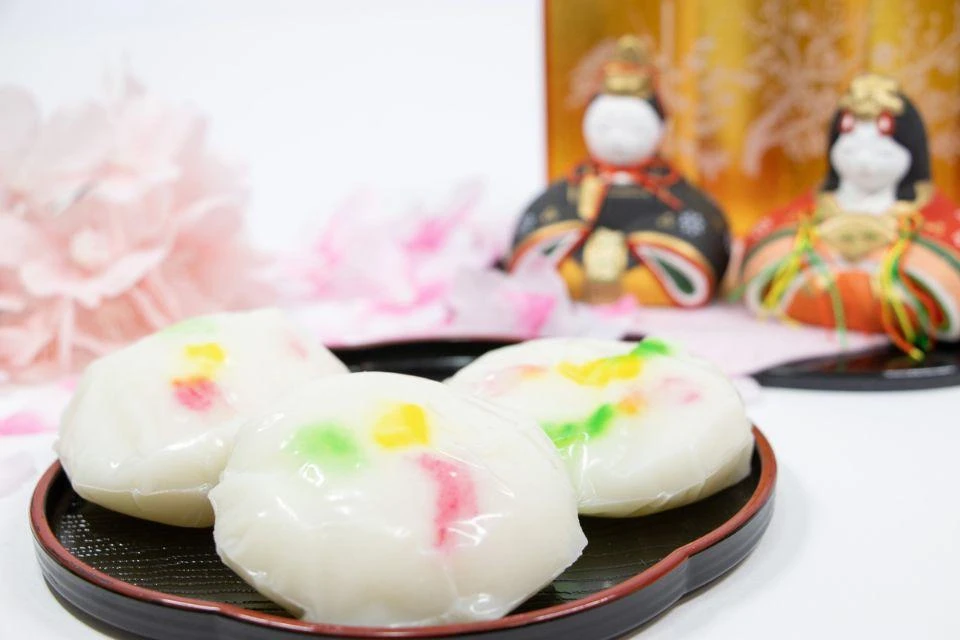 Colorful oshimon confections in front of a display of Girl's Day dolls