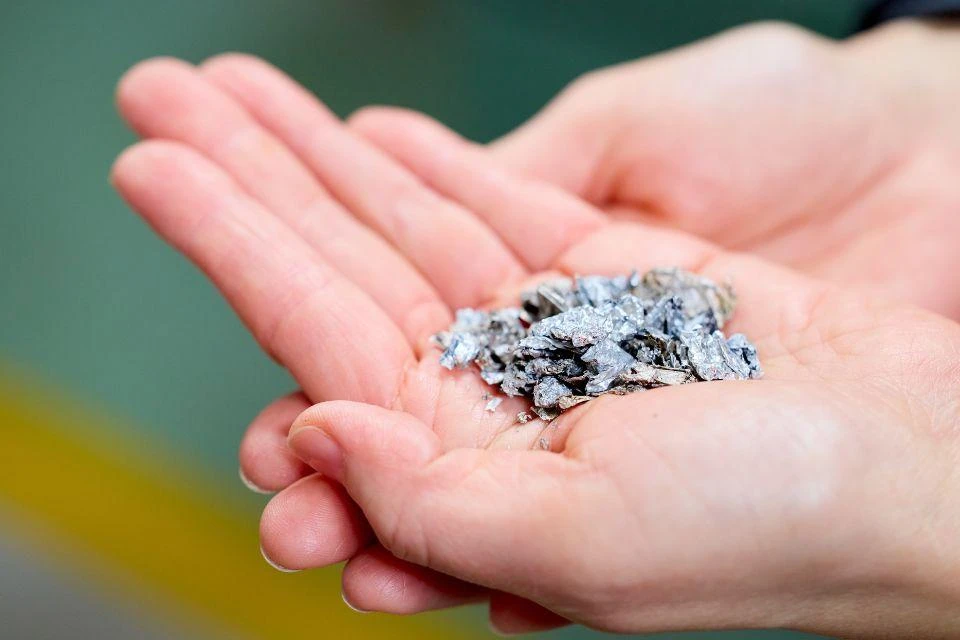 Cupped hands holding dry-distillation aluminum flakes