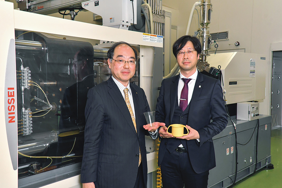 In front of the injection molding machine.