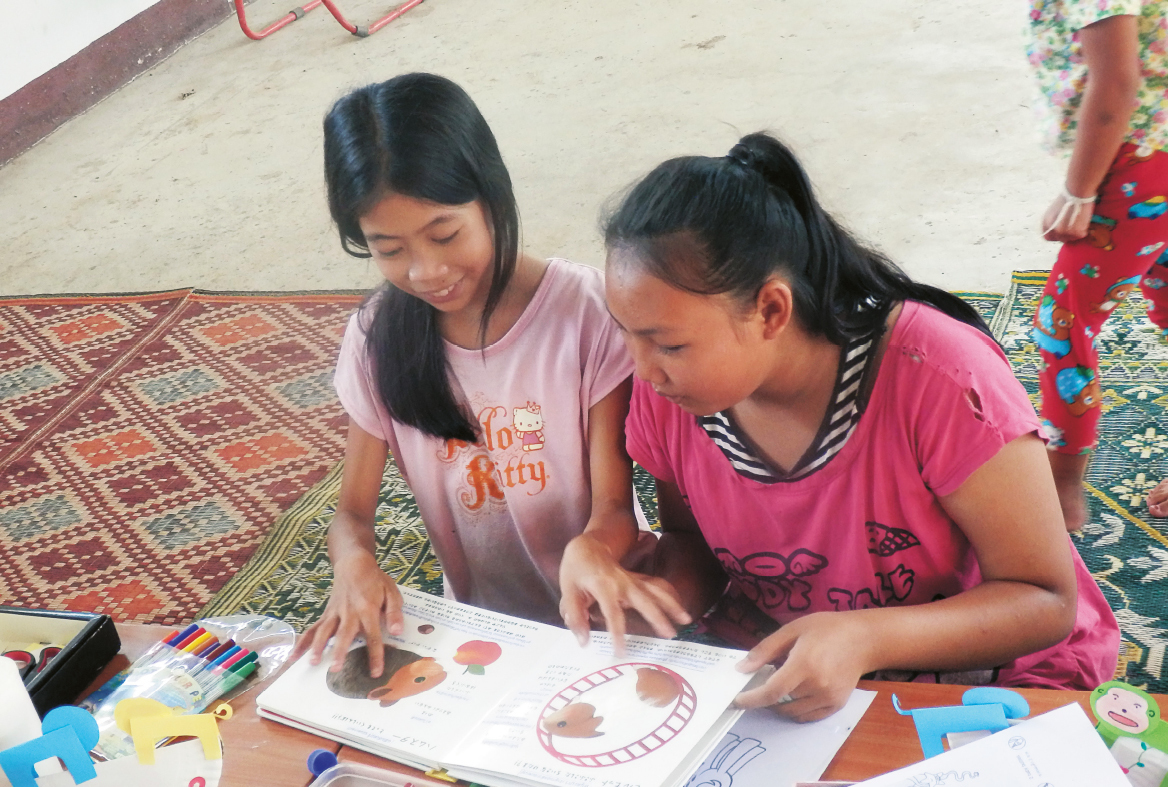 Children enjoying some picture books. Books have been bought with money raised, and many have also been donated.