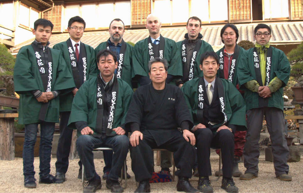 A photo from the time when Brose was learning under Kobayashi, his oyakata (master) at Shunkaen Bonsai Museum. (Kobayashi second from front left; Brose fifth from back left.)