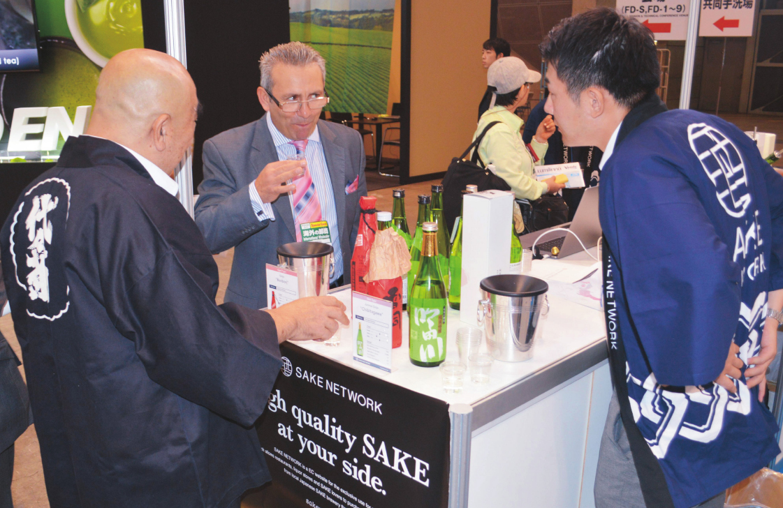 An e-commerce company dealing in specialty Japanese sake for European markets gives a sake tasting to a visitor.