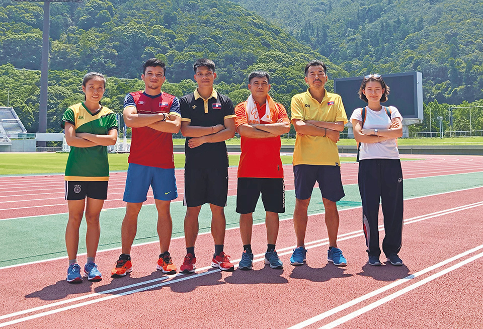Together with athletes of the Lao Paralympic Athletic Team. Hane (second from right) says that he wants to be seen as a role model for overcoming his own struggles with disability and illness.